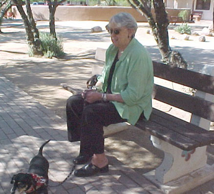 dachshund's owner on the bench before mass